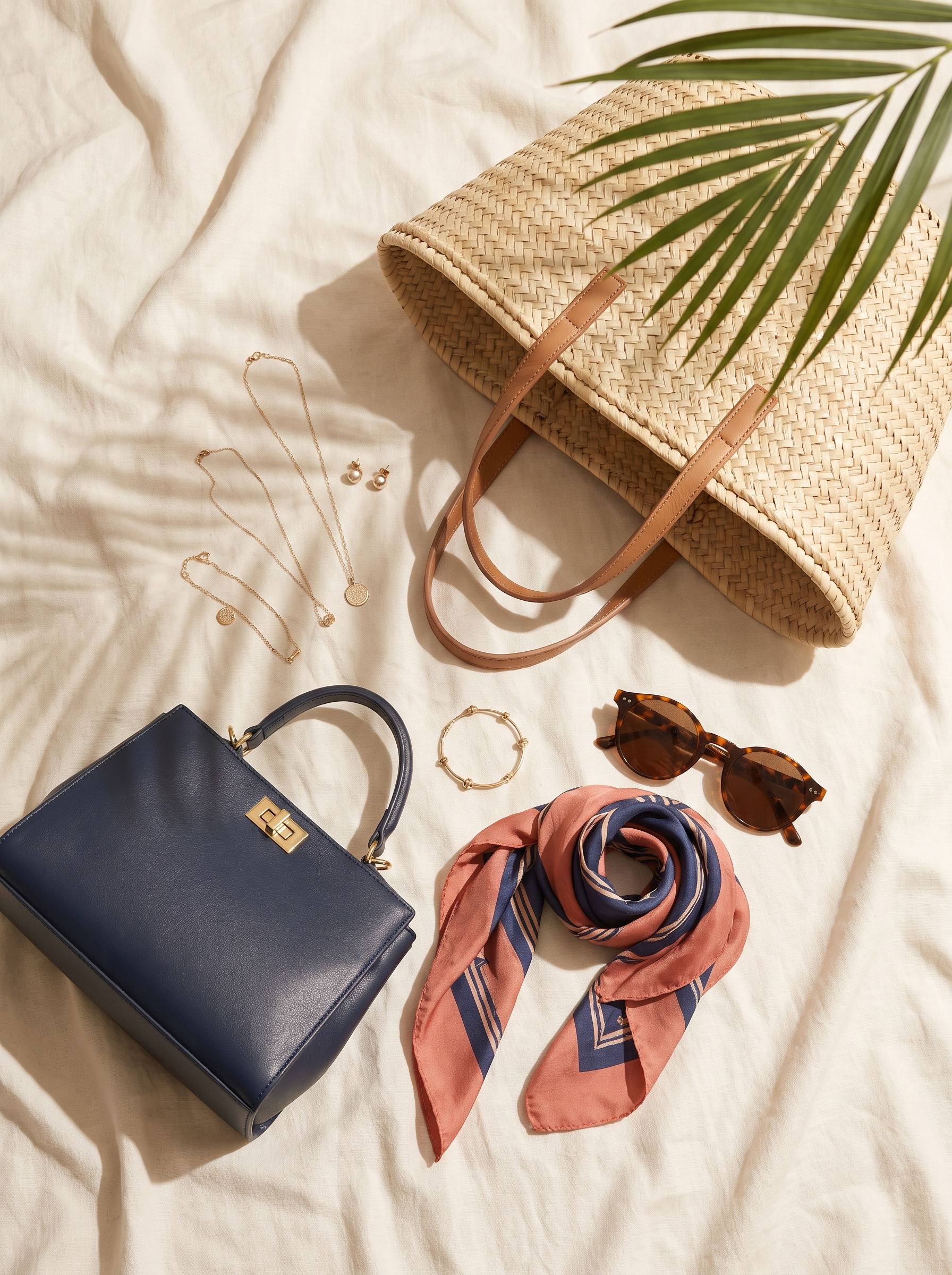 Resort accessories arranged on ivory linen